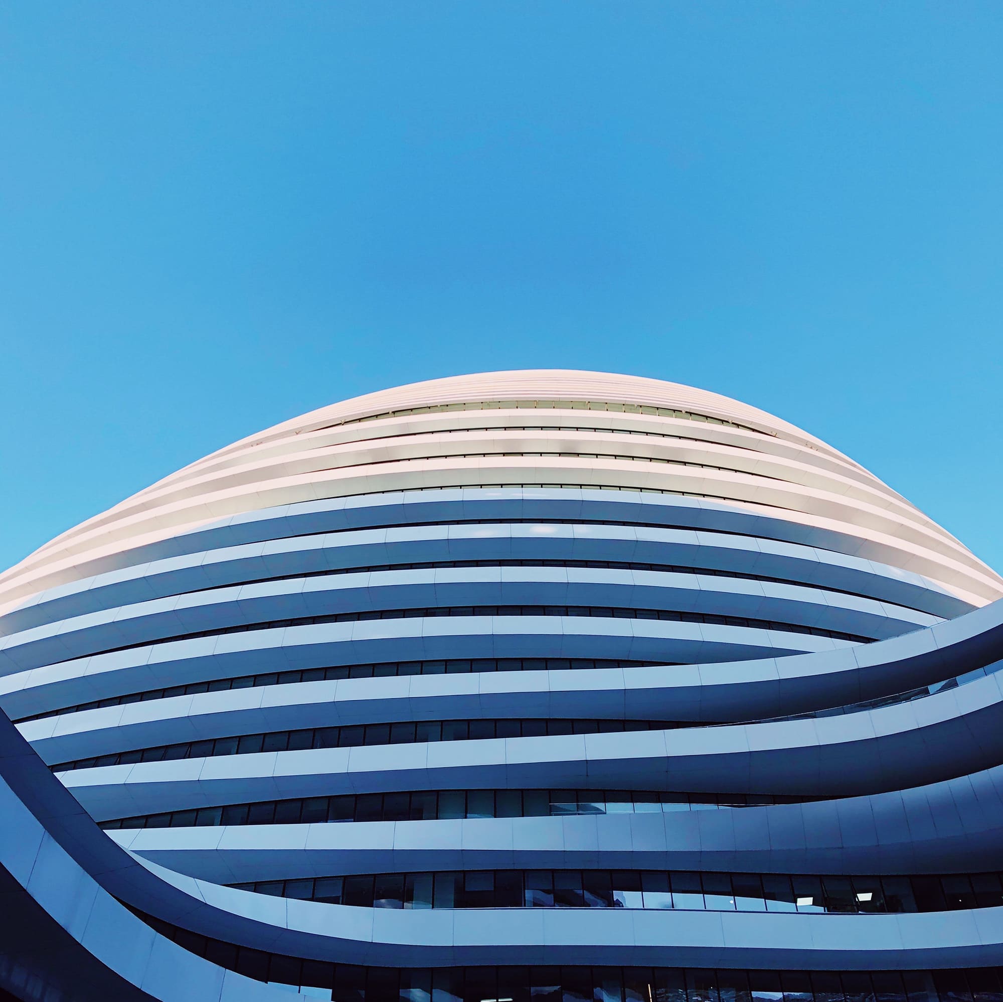 White high-rise building over blue sky at daytime